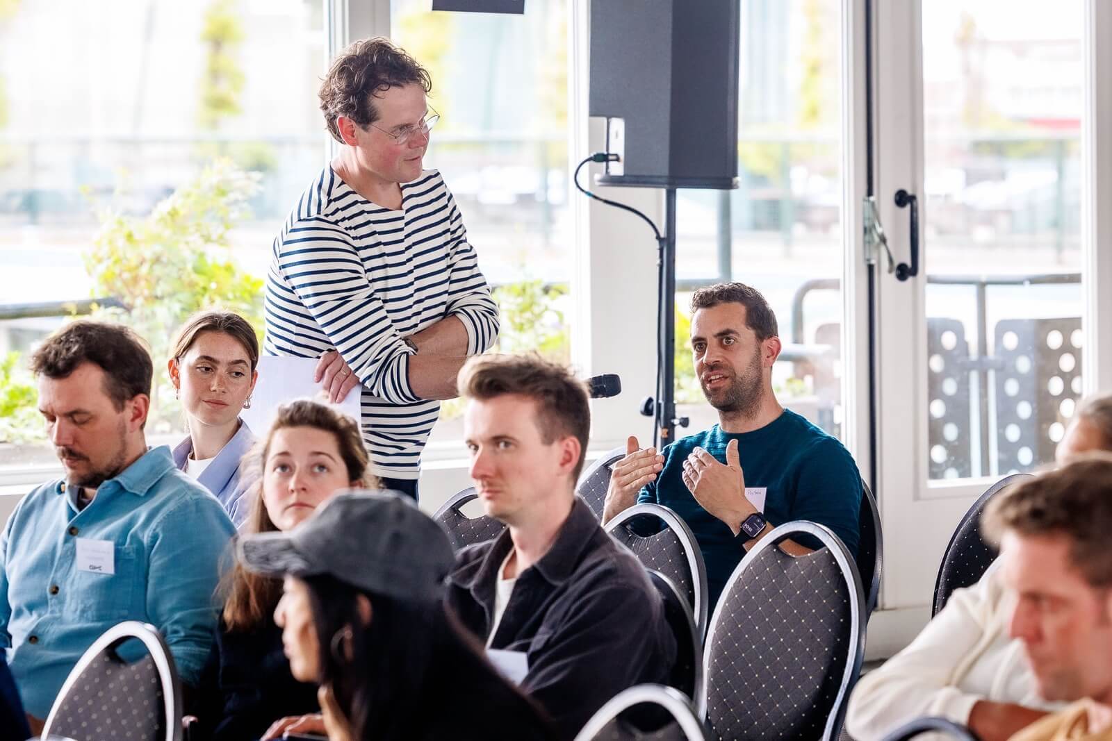 Moderator Servaz van Berkum interviews someone from the audience.